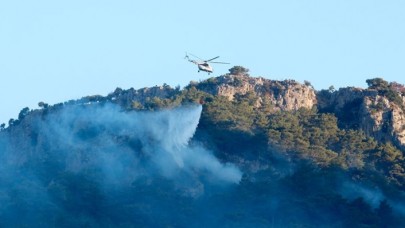 Muğla'da kontrol altına alınan orman yangınına müdahale ediliyor
