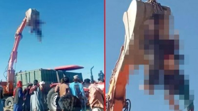 Taliban'dan kan donduran idam! Bu kez de öldürdükleri adamın cesedini kepçeye astılar