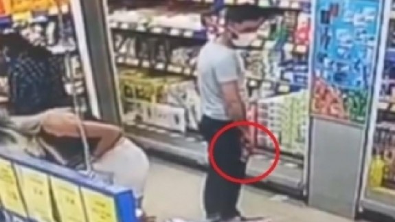 Alışveriş yapan kadının gizlice fotoğraflarını çeken kişi kamerada